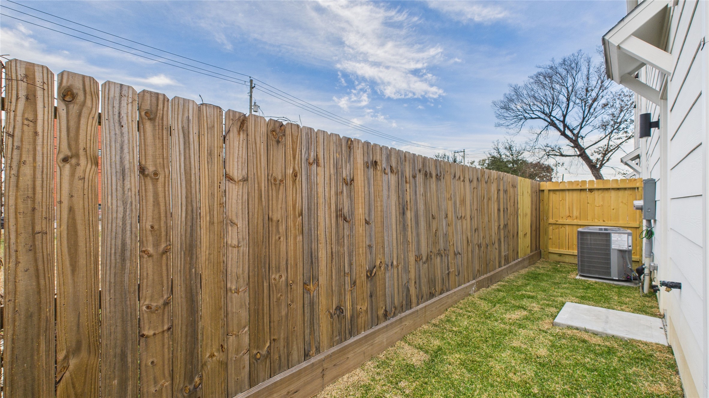 2426 Freeman Street Houston, TX 77009 - Photo 8 of 47 This cozy backyard patio offers a charming outdoor retreat, accessible directly from the secondary bedroom and through a wooden gate that leads to the driveway, providing convenient indoor-outdoor flow and added privacy.