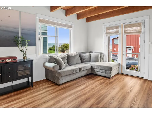 a living room with furniture and large window