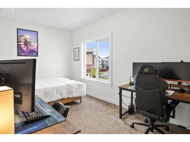 a bedroom with a bed and a desk