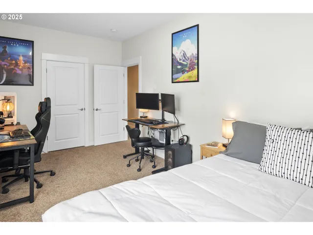 a bedroom with a bed and a desk