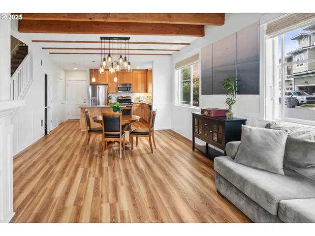a dining room with furniture and wooden floor