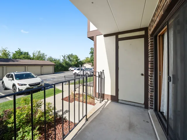 a car parked in front of a white house