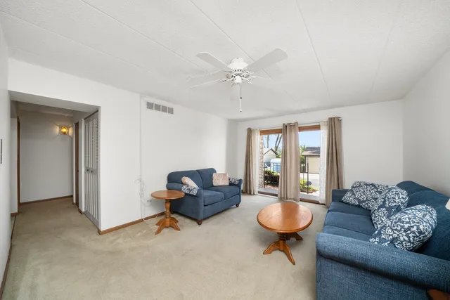 a living room with furniture a table and a large window