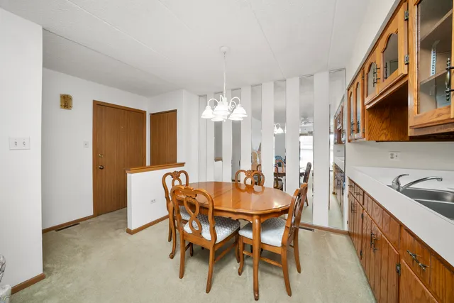 a view of a dining room with furniture and chandelier