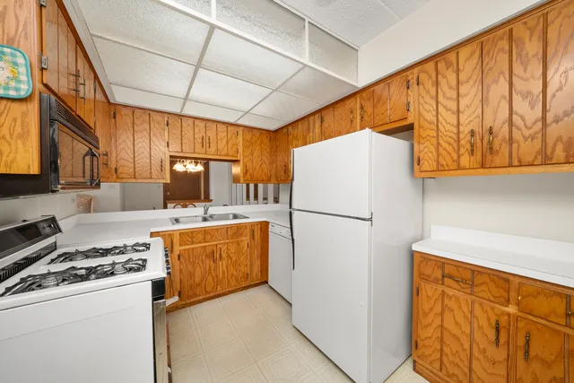 a kitchen with a refrigerator a stove top oven a sink and dishwasher