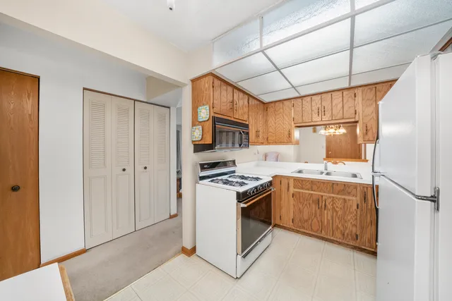 a kitchen with stainless steel appliances granite countertop a stove a refrigerator and a refrigerator