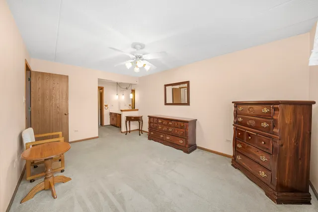 a spacious bedroom with a bed and cabinets