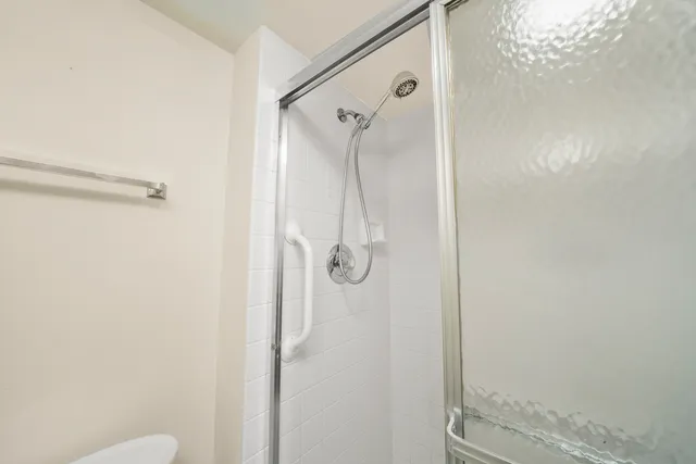 a bathroom with a glass shower door