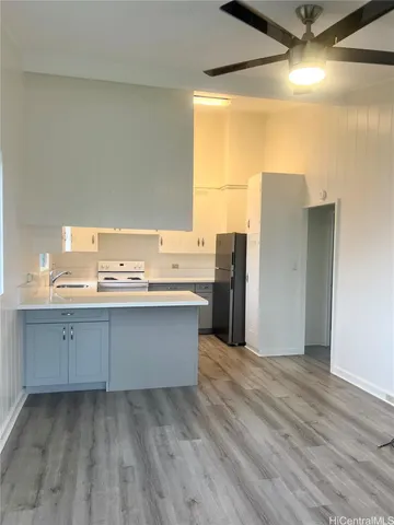 a room with a sink cabinets and wooden floor