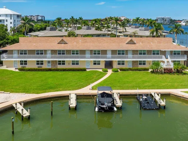 an aerial view of a house with a garden and lake view