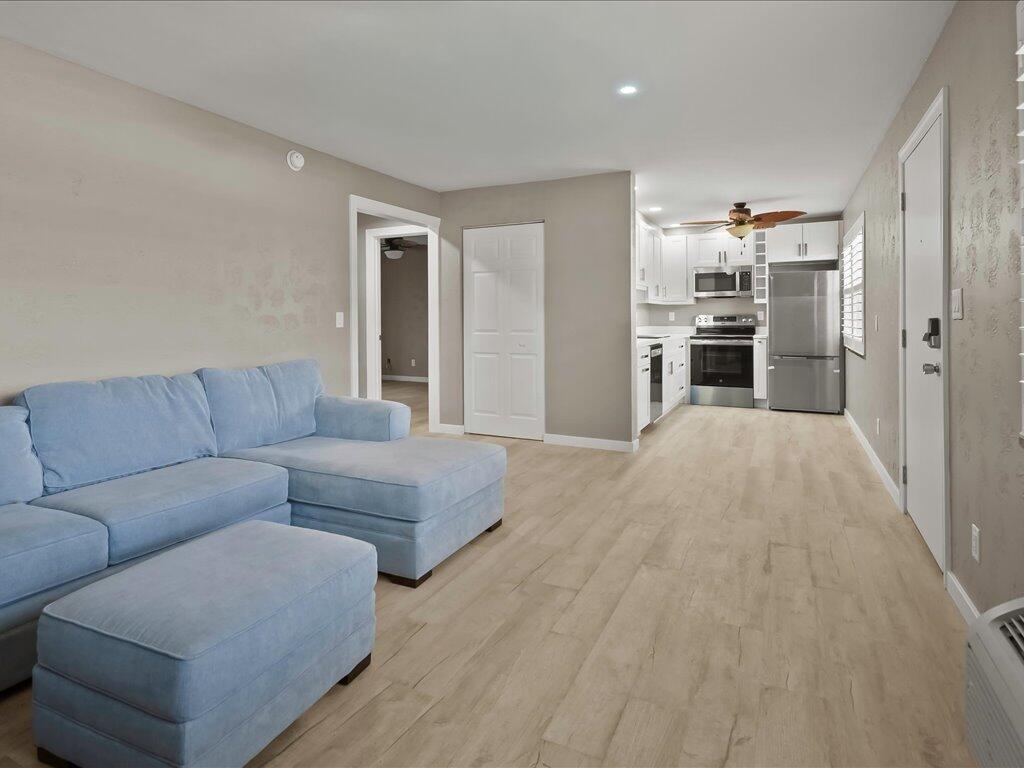 850 Palm Street, Unit E2 Marco Island, FL 34145 - Photo 8 of 23 a living room with furniture and kitchen view