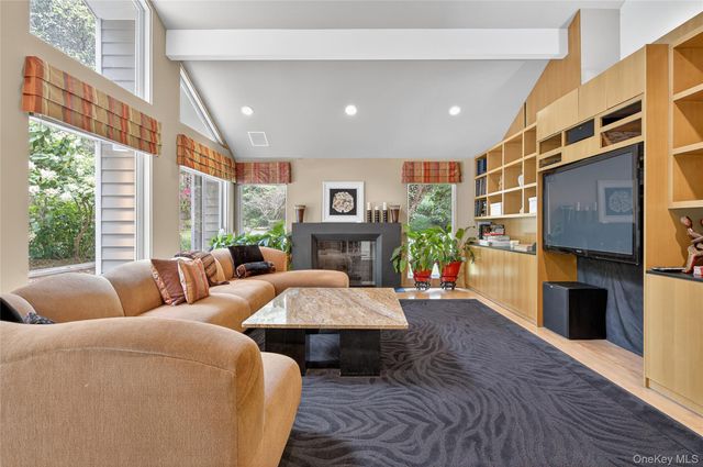 a living room with fireplace furniture and a fireplace