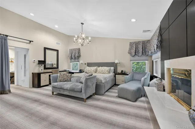 a spacious bedroom with a bed and a flat screen tv