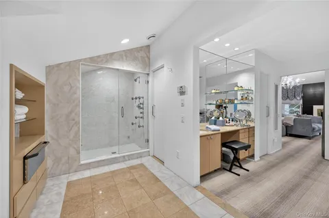 a white bath tub sitting in a bathroom next to a window