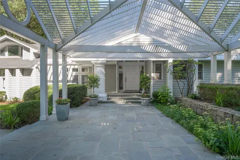a view of a patio with table and chairs and potted plants