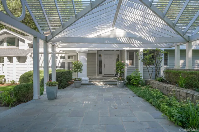 a view of a patio with table and chairs and potted plants