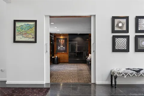a view of a hallway with wooden floor and furniture