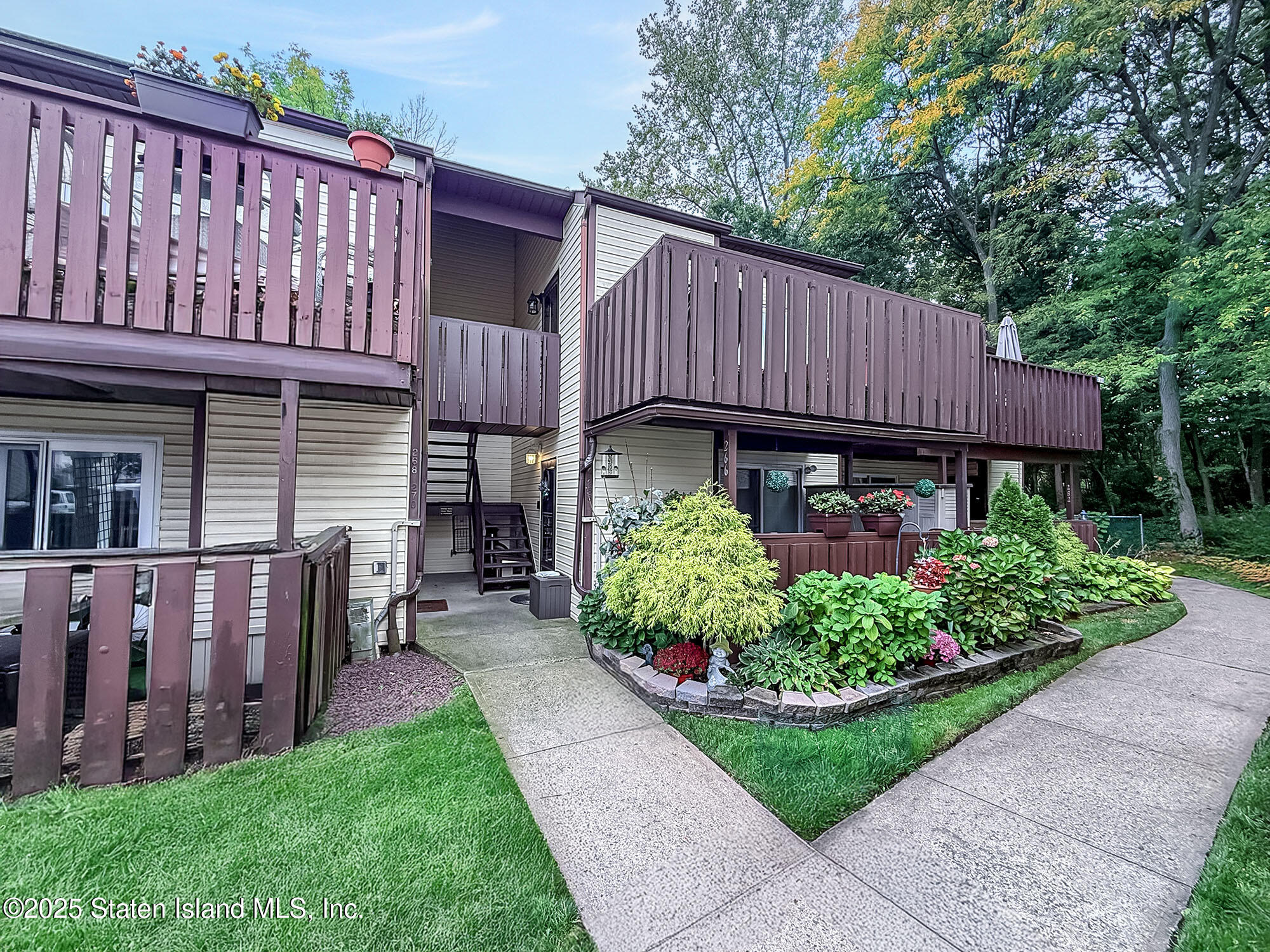 264 Timber Ridge Drive Staten Island, NY 10306 - Photo 1 of 31 a view of backyard with potted plants and a wooden fence
