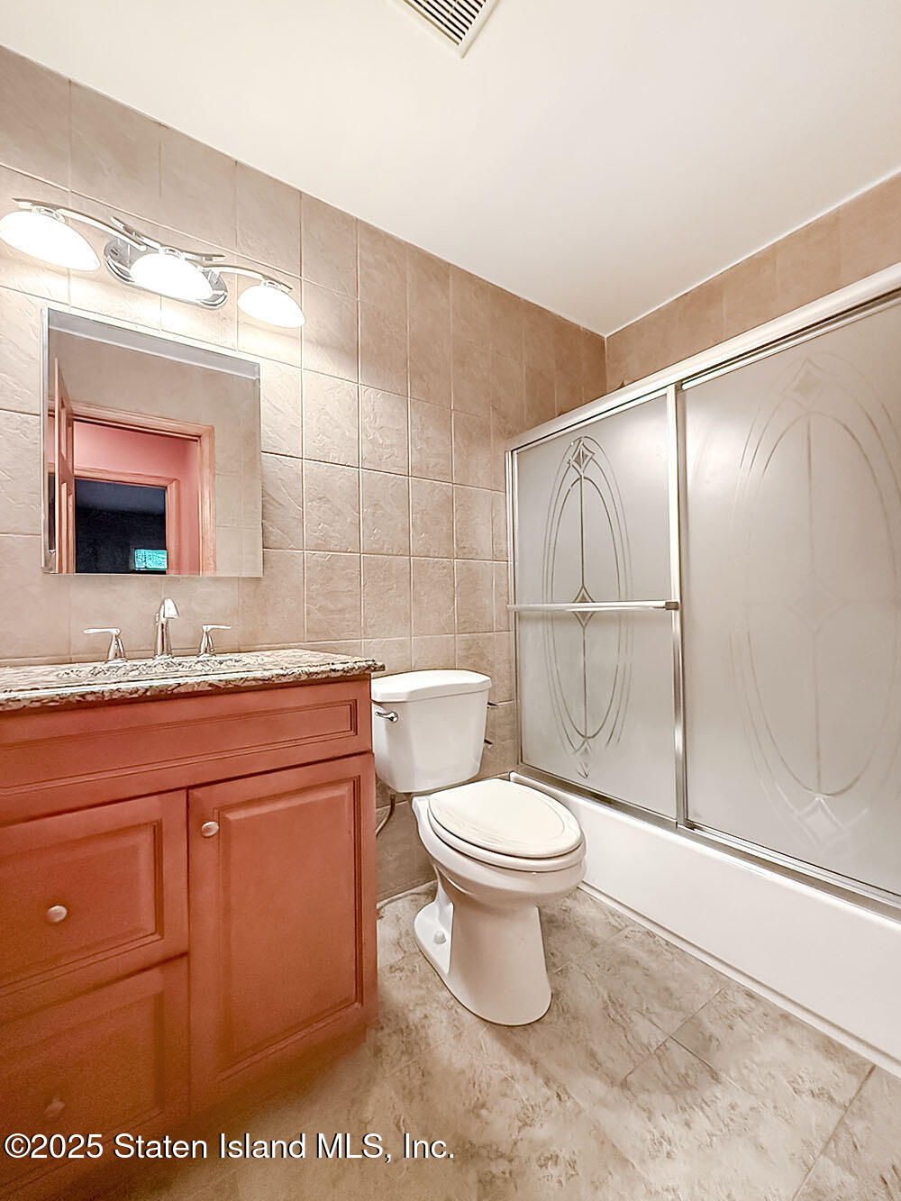 264 Timber Ridge Drive Staten Island, NY 10306 - Photo 14 of 31 a bathroom with a sink a toilet and mirror