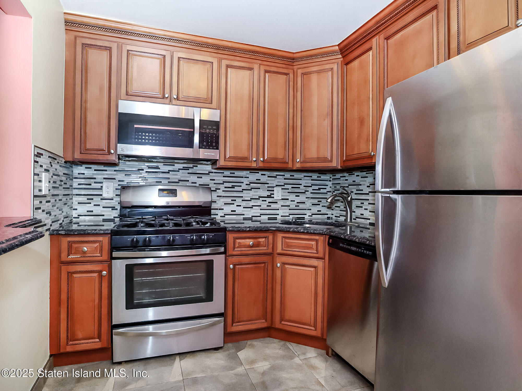 264 Timber Ridge Drive Staten Island, NY 10306 - Photo 8 of 31 a kitchen with stainless steel appliances granite countertop a refrigerator stove and microwave