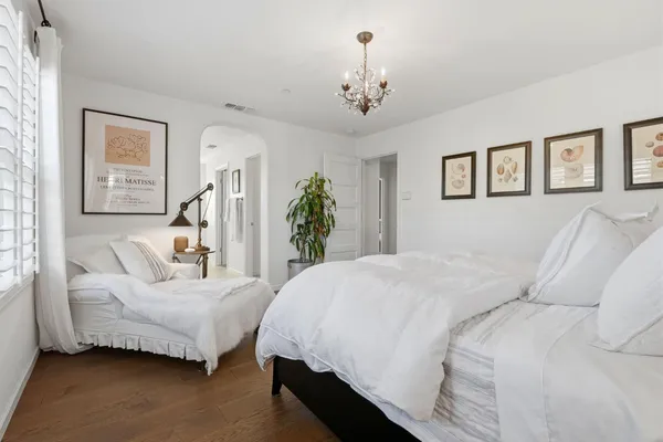 a view of a patio with couches table and chairs and potted plants