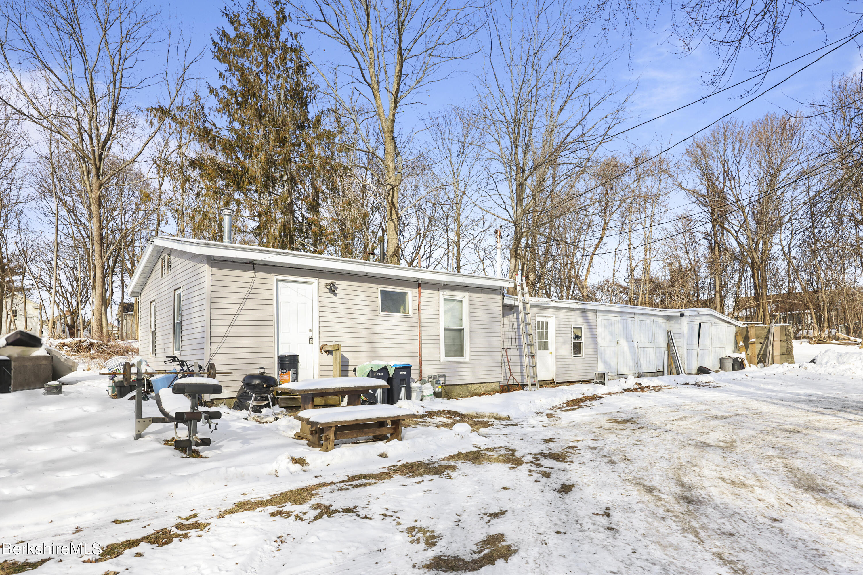 a view of a house with a yard covered in snow