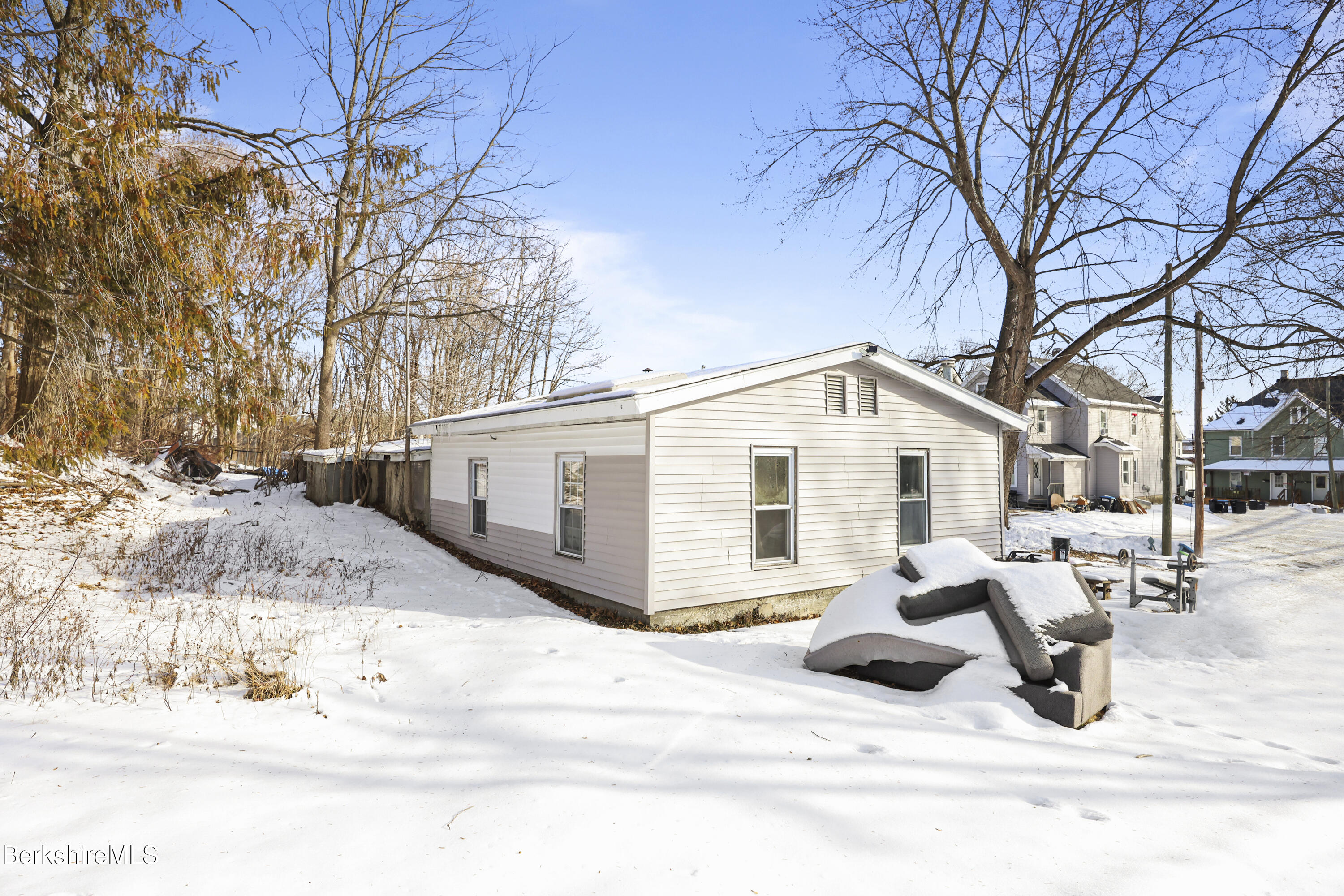 1 1/2 Cherry Street Pittsfield, MA 01201 - Photo 16 of 23 a view of a white house covered in snow