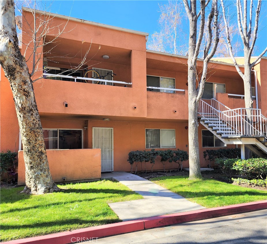 12601 Van Nuys Boulevard, Unit 138 Pacoima, CA 91331 - Photo 1 of 19 a front view of a house with a yard and garage