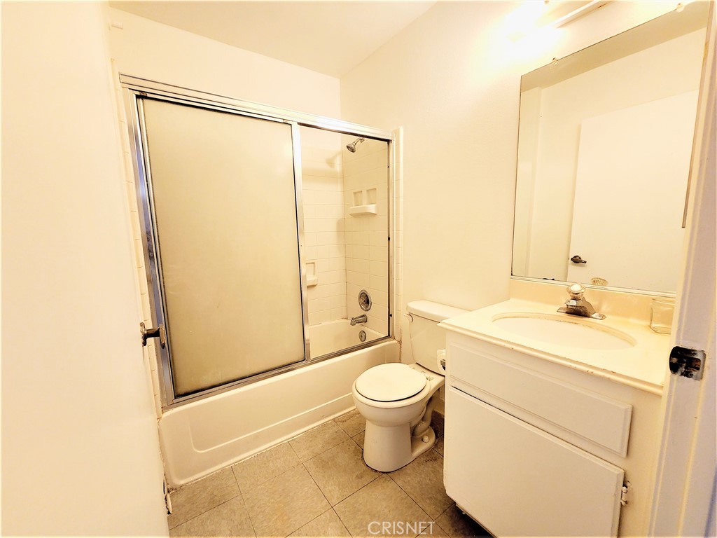 12601 Van Nuys Boulevard, Unit 138 Pacoima, CA 91331 - Photo 11 of 19 a bathroom with a granite countertop sink toilet and shower