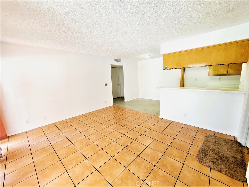 12601 Van Nuys Boulevard, Unit 138 Pacoima, CA 91331 - Photo 4 of 19 a bedroom with a bed and a night stand