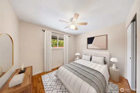 a bedroom with a bed and a painting on the wall