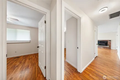 a view of a hallway view with wooden floor and staircase