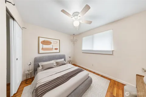 a bedroom with a large bed and a window