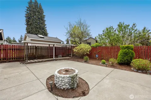 a view of a chairs and table in the back yard