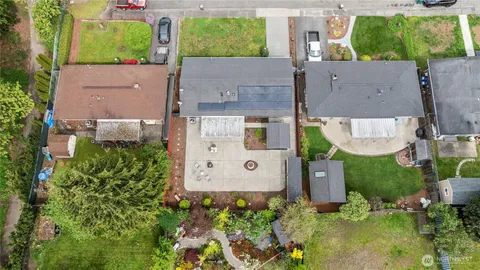 an aerial view of a house with a yard basket ball court and outdoor seating