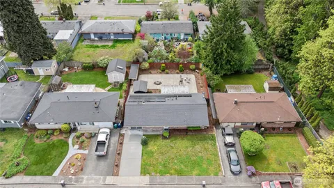 an aerial view of a house with a garden and swimming pool