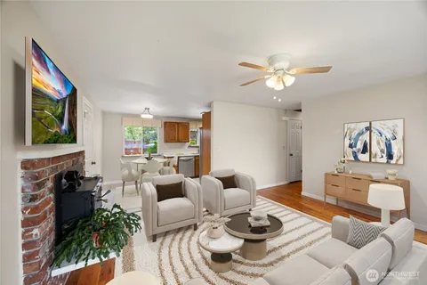 a living room with furniture potted plant and a fireplace