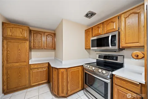 a kitchen with stainless steel appliances granite countertop a stove microwave and refrigerator