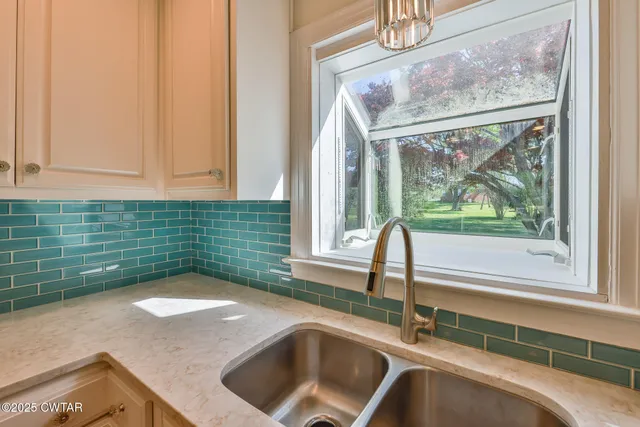 a kitchen with a sink and a window