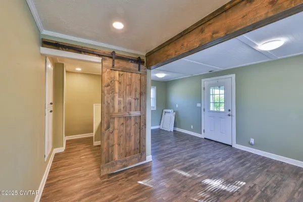 a view of empty room with wooden floor