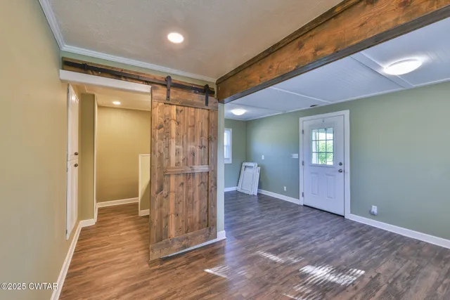 a view of empty room with wooden floor