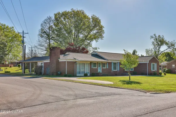 a front view of house with yard and green space