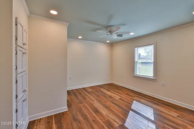 wooden floor in an empty room with a window