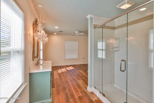 a bathroom with a glass shower door and a sink