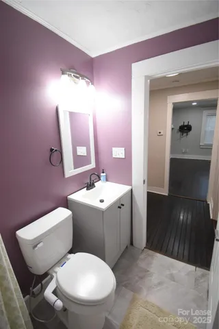 a bathroom with a toilet a sink and mirror