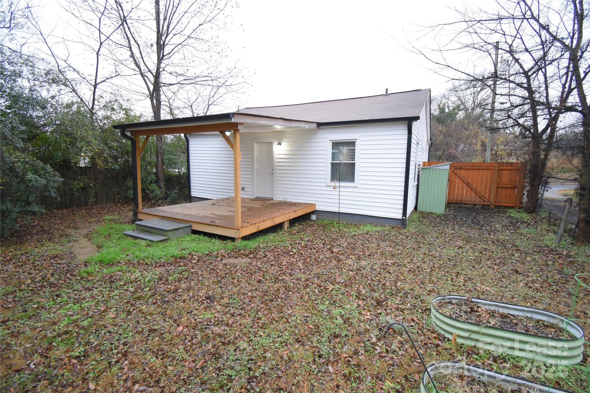 199 Crowell Drive Southwest Concord, NC 28025 - Photo 17 of 19 a backyard of a house with a garden and barbeque oven
