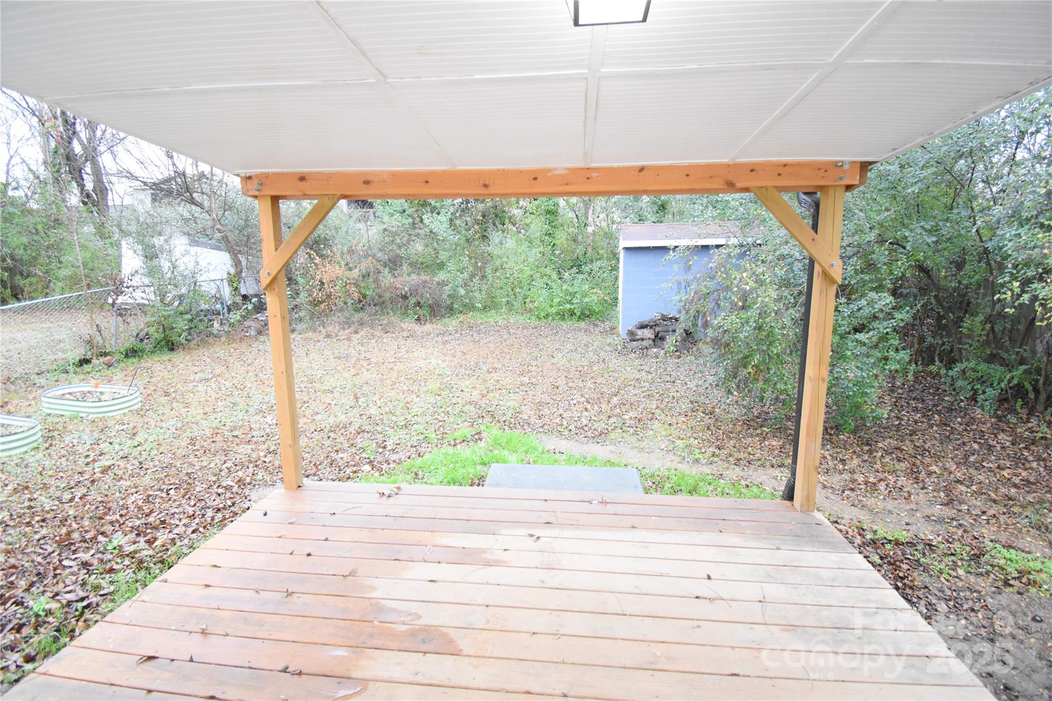 199 Crowell Drive Southwest Concord, NC 28025 - Photo 18 of 19 a backyard of a house with large trees and plants