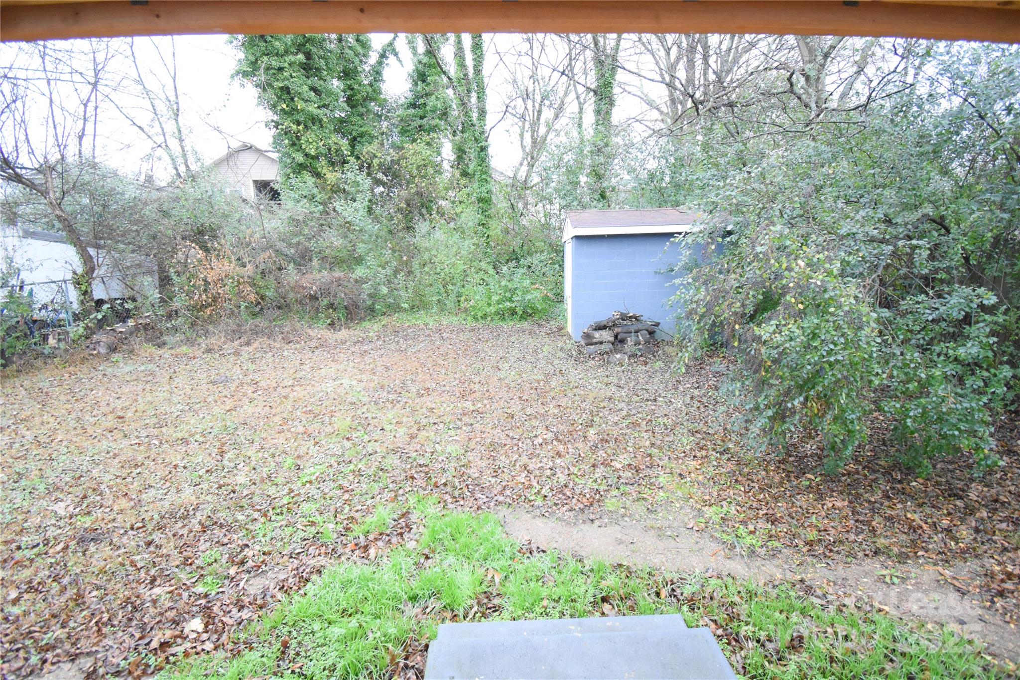 199 Crowell Drive Southwest Concord, NC 28025 - Photo 19 of 19 a backyard of a house with large trees and wooden fence