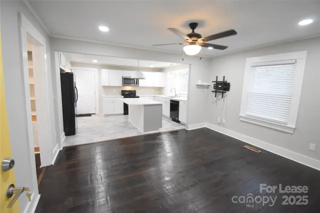 a view of a kitchen with a sink stainless steel appliances and cabinets