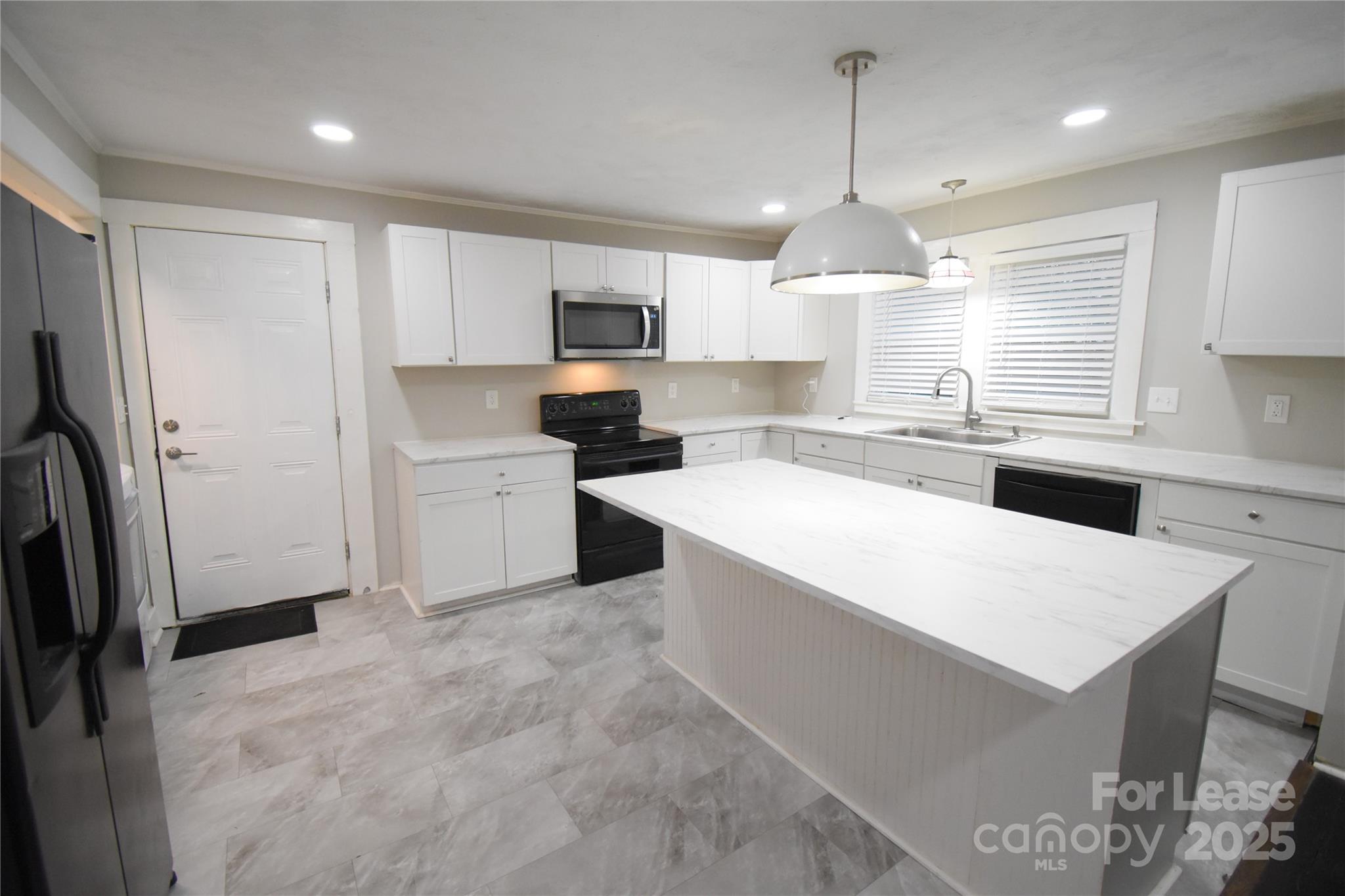 199 Crowell Drive Southwest Concord, NC 28025 - Photo 5 of 19 a kitchen with stainless steel appliances a microwave sink and refrigerator